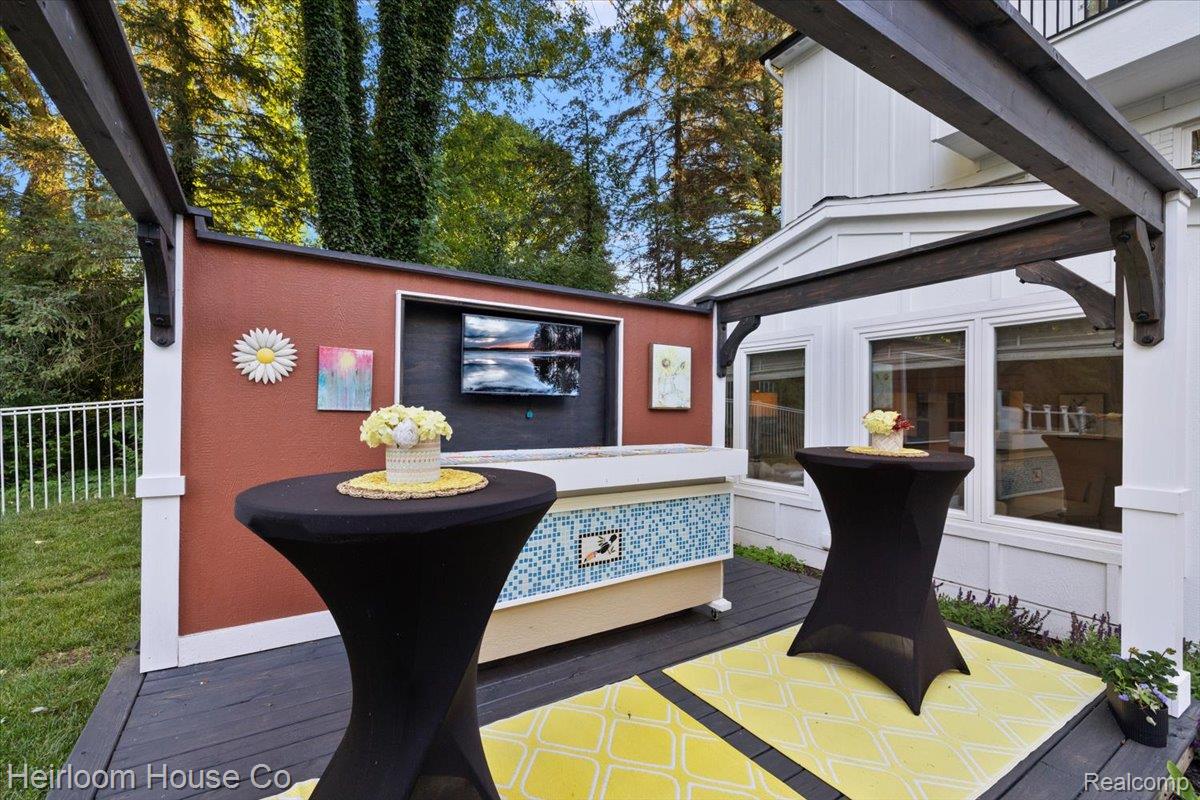 49001 Hanford Road Canton, MI 48187 - Photo 35 of 98 Outdoor entertainment area featuring a mounted television, a tiled bar, and a dark wood pergola