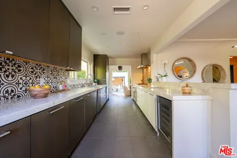 a spacious bedroom with a bed and a potted plant