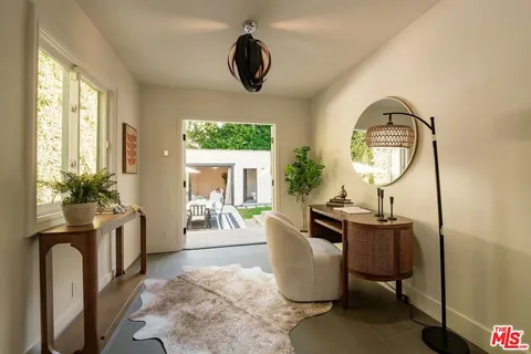 a view of a patio with a table and chairs under an umbrella
