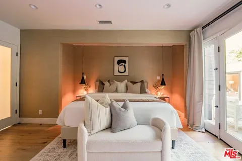 a living room with furniture and a large mirror