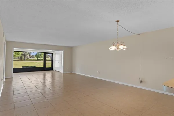 a view of an empty room with a fireplace and a window