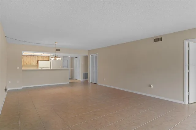 a kitchen with granite countertop cabinets stainless steel appliances and a counter space