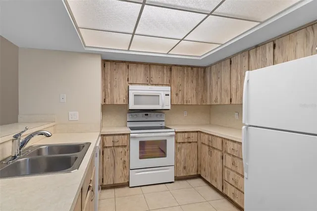 a bathroom with a granite countertop sink mirror and