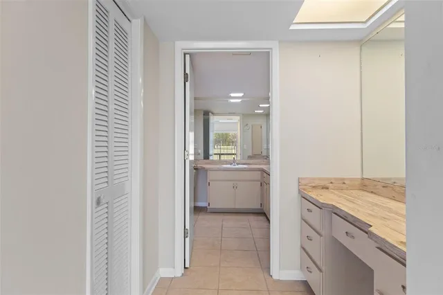 a view of a hallway with a livingroom and a bathroom