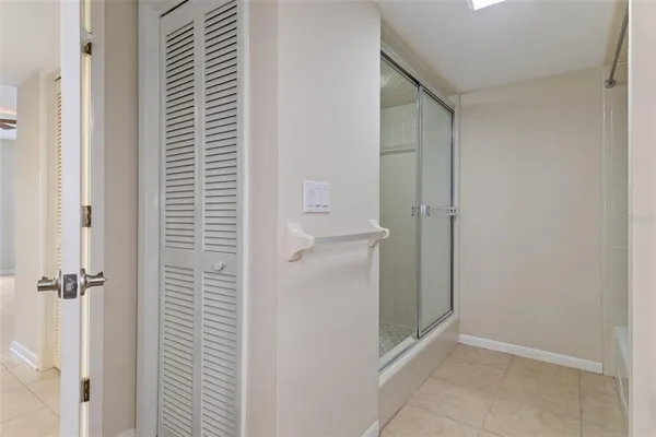 a view of a hallway with a livingroom and a bathroom