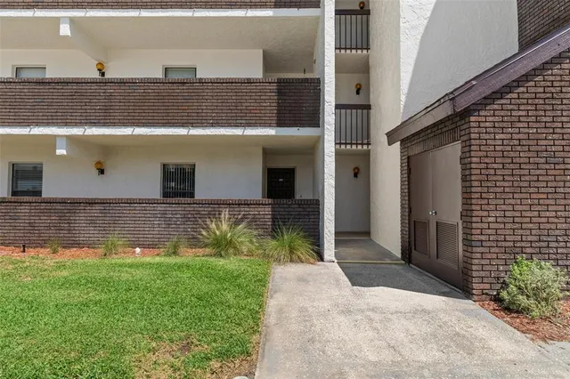 a view of a hallway with wooden floor and windows