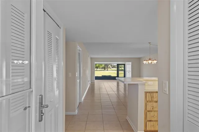 a view of an empty room with a fireplace and a window