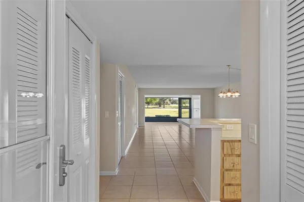 a view of a room with a ceiling fan and a window