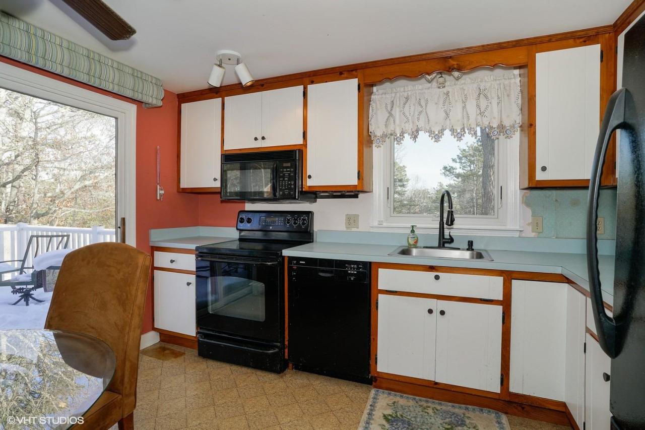 60 Ridge St Extension Wellfleet, MA 02667 - Photo 9 of 21 a kitchen with stainless steel appliances granite countertop a stove a sink and a microwave