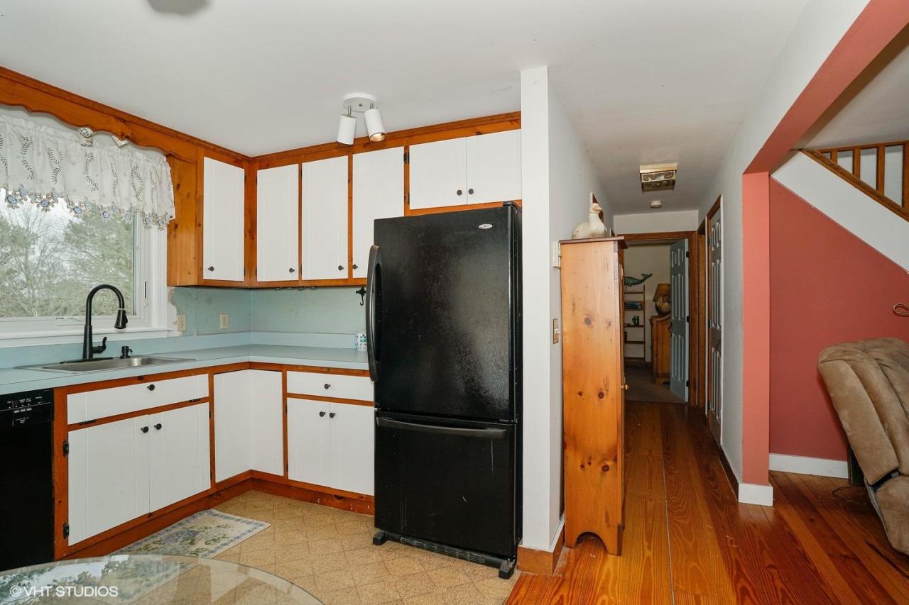 60 Ridge St Extension Wellfleet, MA 02667 - Photo 10 of 21 a kitchen with stainless steel appliances a refrigerator sink and cabinets