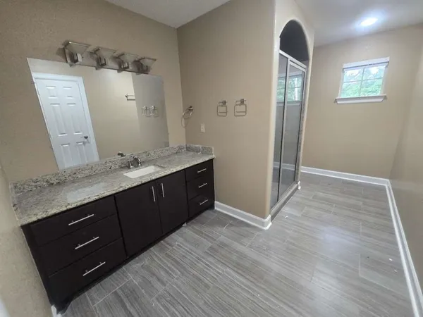 a bathroom with a double vanity sink and mirror