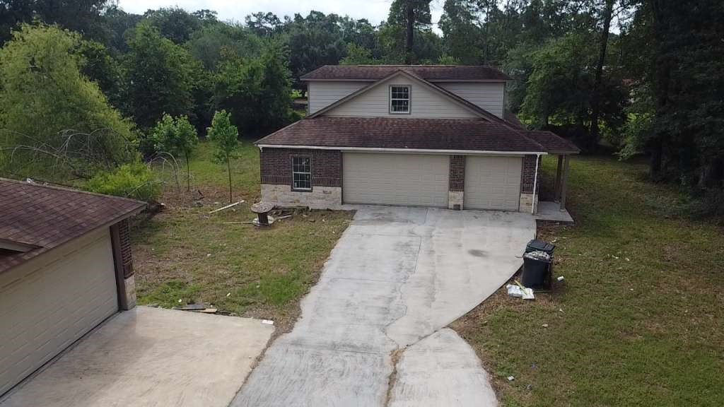 11529 Warner Road Cleveland, TX 77328 - Photo 22 of 27 a front view of house with yard and trees in the background