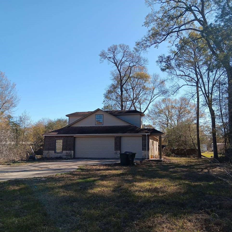11529 Warner Road Cleveland, TX 77328 - Photo 23 of 27 a front view of a house with a garden