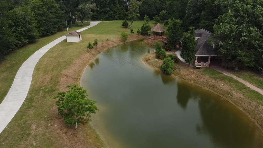 11529 Warner Road Cleveland, TX 77328 - Photo 3 of 27 a view of a lake with a house