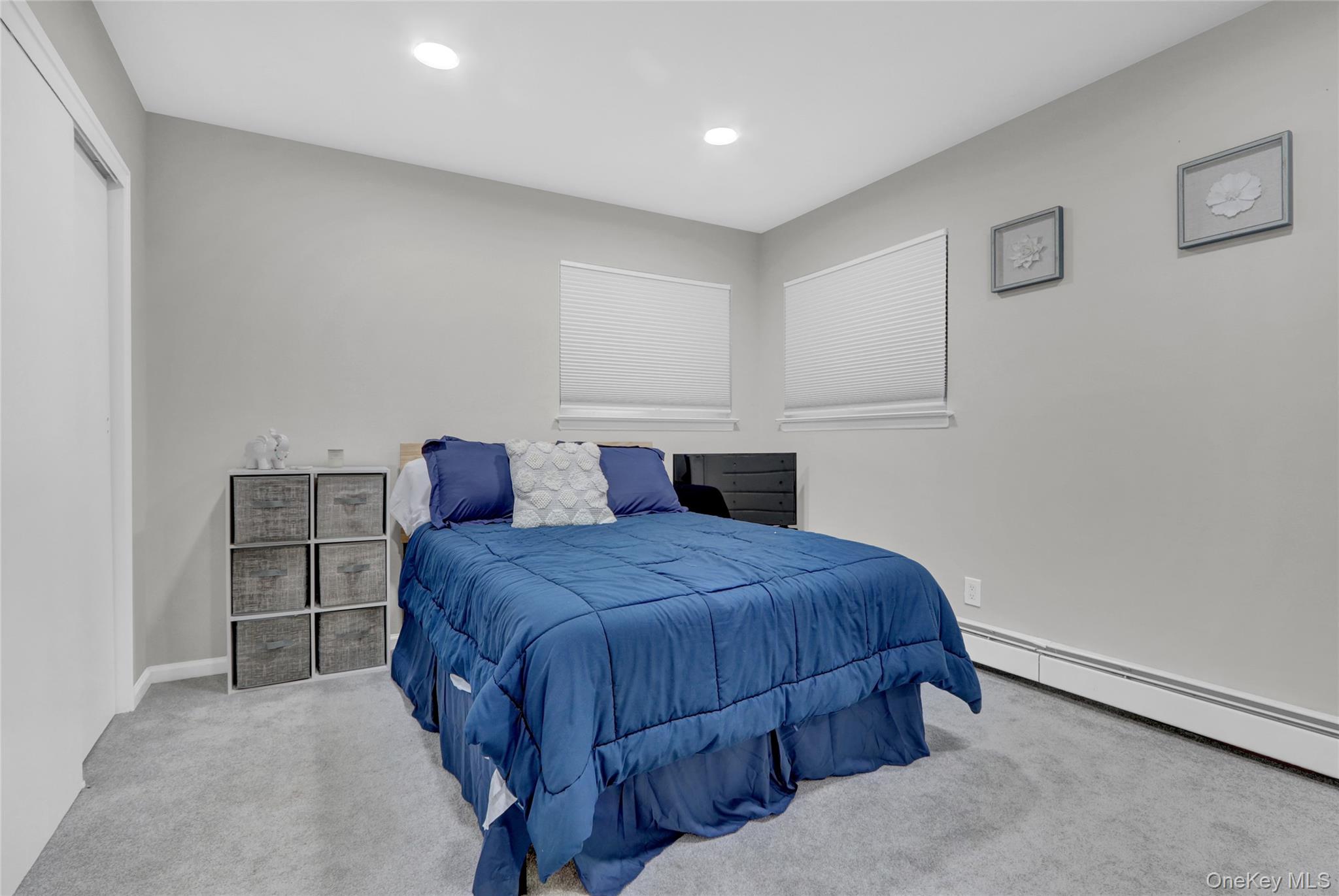 220 East Chester Street Long Beach, NY 11561 - Photo 17 of 26 a bedroom with a bed and a cabinets