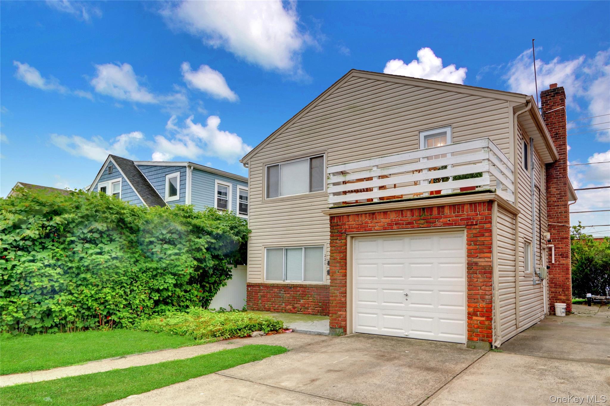 220 East Chester Street Long Beach, NY 11561 - Photo 2 of 26 a front view of a house with a yard