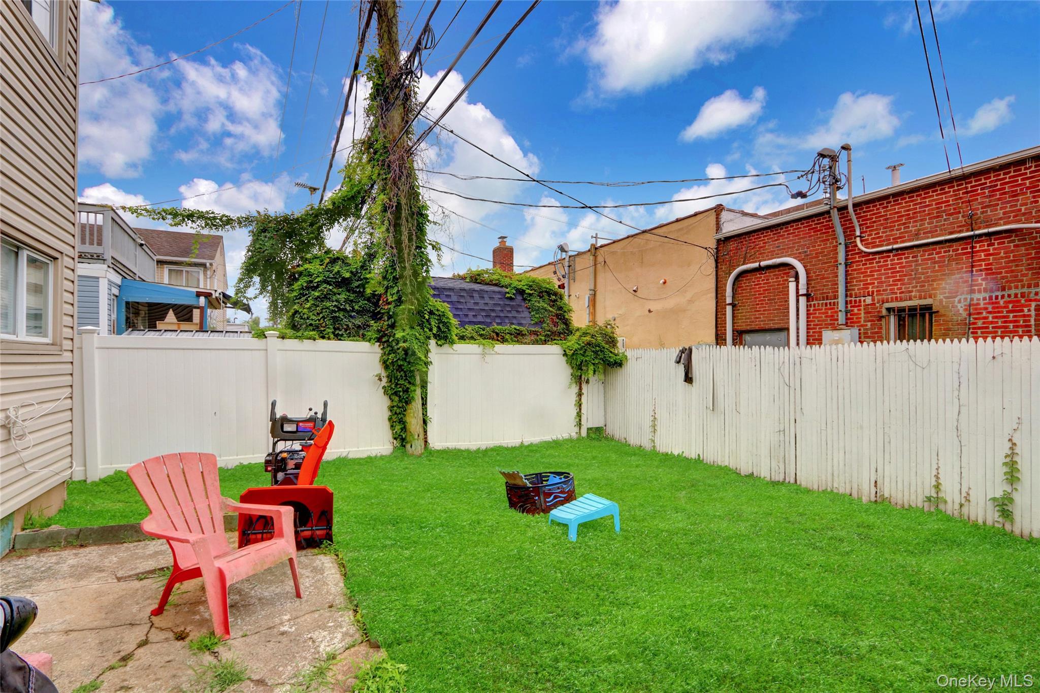 220 East Chester Street Long Beach, NY 11561 - Photo 23 of 26 a backyard of a house with table and chairs