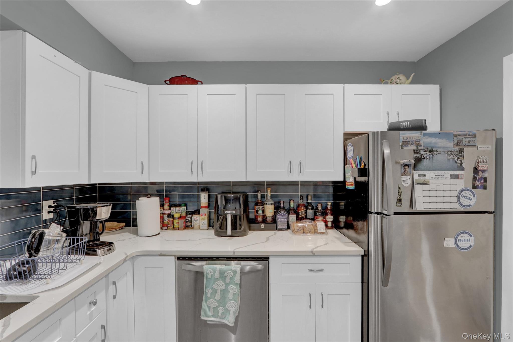220 East Chester Street Long Beach, NY 11561 - Photo 7 of 26 a kitchen with refrigerator and cabinets