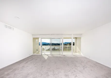 a view of an empty room with a sliding door