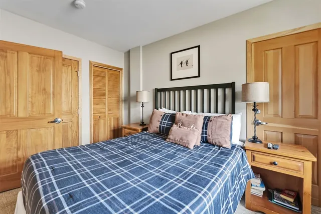 a bedroom with a large bed and a flat screen tv