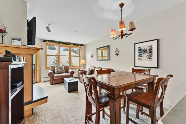 a living room with a couch wooden floor and a window