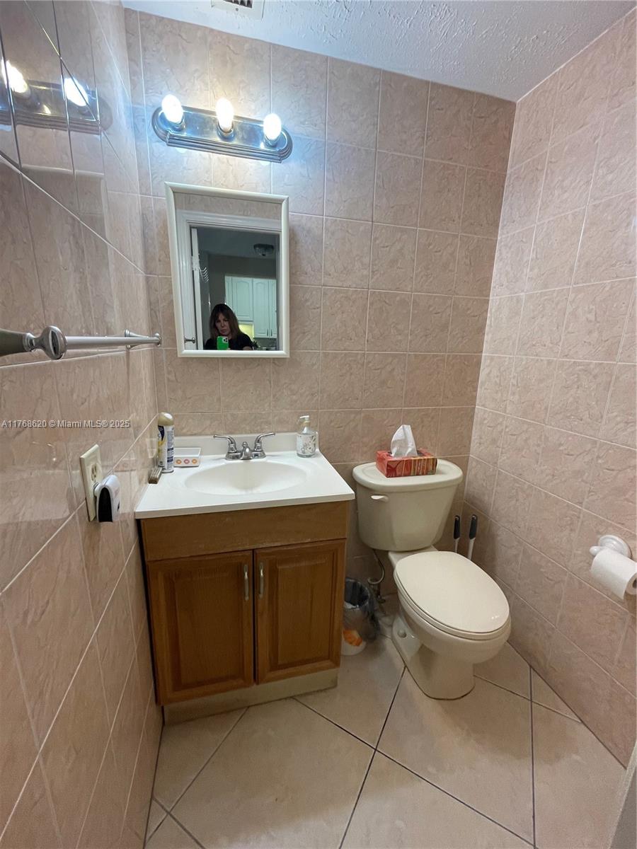 Oceanside Hallandale Beach, FL 33009 - Photo 23 of 49 a bathroom with a sink toilet and a mirror