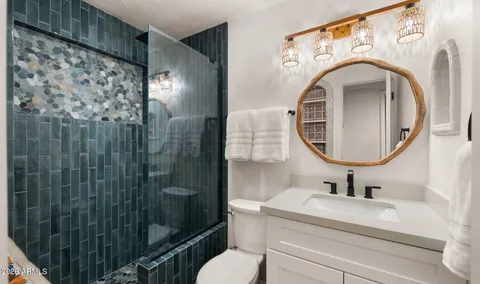 a bedroom with a bed and a painting on the wall