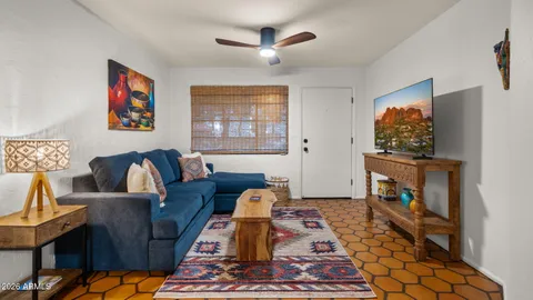 a bathroom with a granite countertop sink a mirror a bathtub and shower