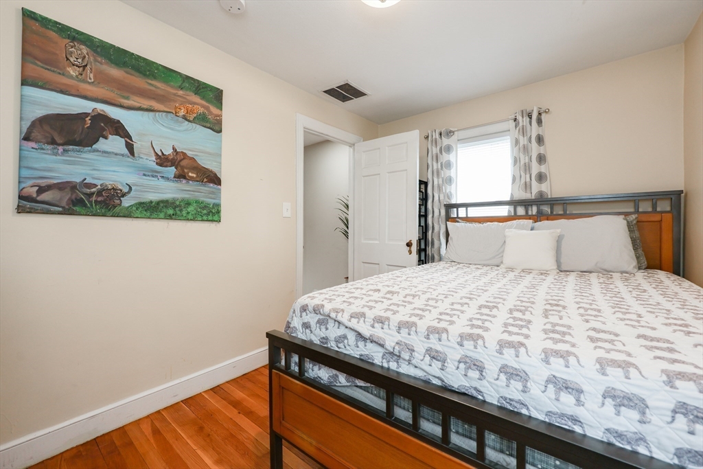 14 Cardinal Road Worcester, MA 01602 - Photo 24 of 28 a bedroom with a bed and painting on the wall