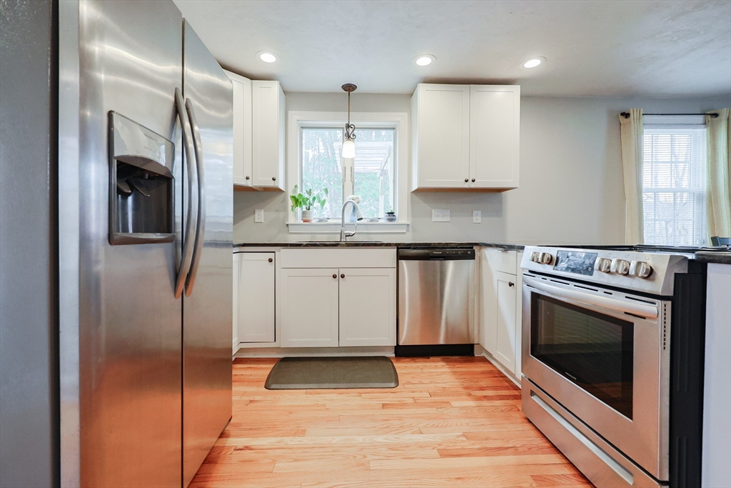 14 Cardinal Road Worcester, MA 01602 - Photo 5 of 28 a kitchen with stainless steel appliances granite countertop a stove a sink and a refrigerator