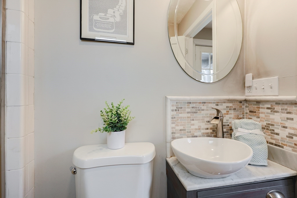 14 Cardinal Road Worcester, MA 01602 - Photo 9 of 28 a bathroom with a toilet a sink and a mirror