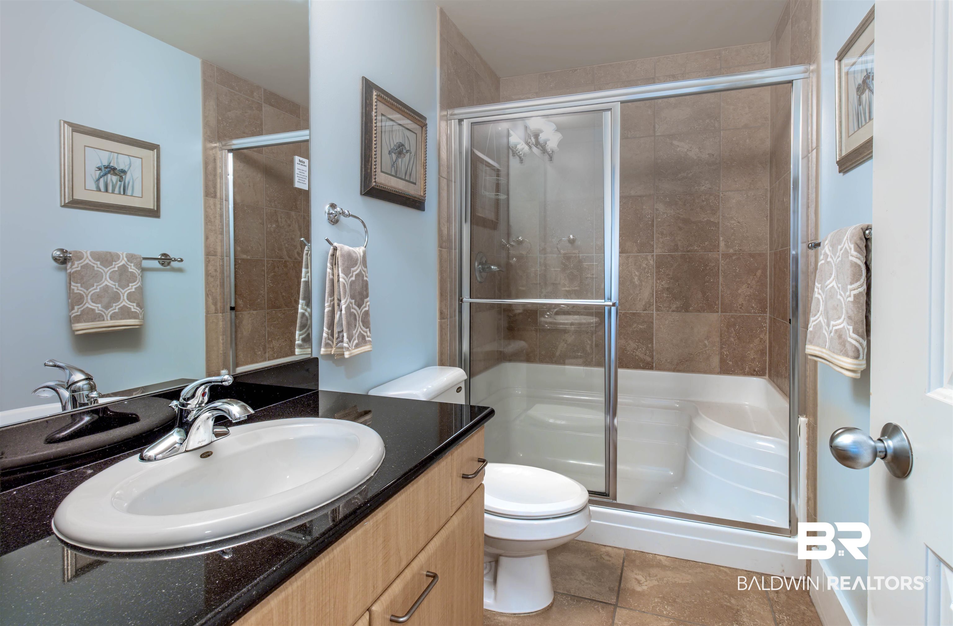 28107 Perdido Beach Boulevard, Unit D714 Orange Beach, AL 36561 - Photo 41 of 88 Full bathroom featuring a shower stall, toilet, and vanity
