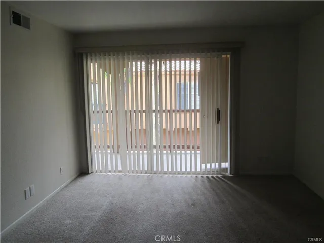 a view of empty room with floor to ceiling window