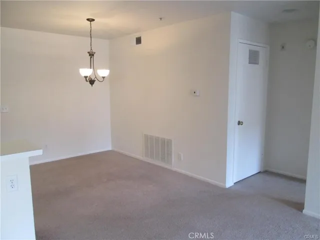 a kitchen with a refrigerator and a stove top oven