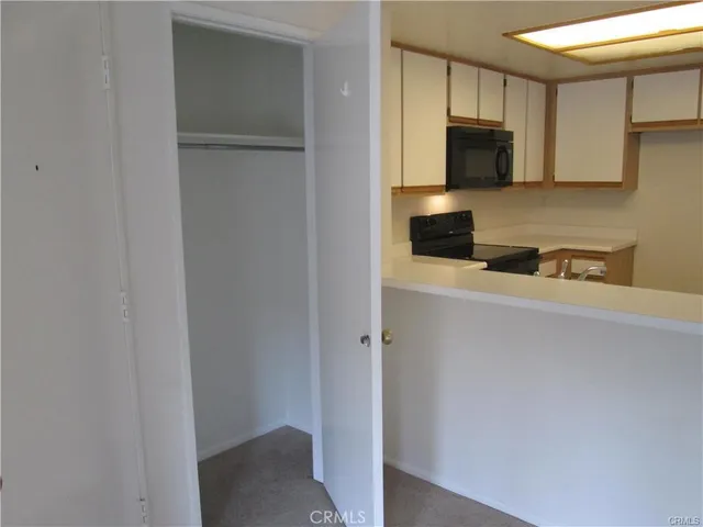 a view of an empty room and closet