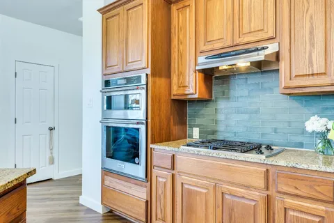 a kitchen with stainless steel appliances granite countertop a sink and cabinets