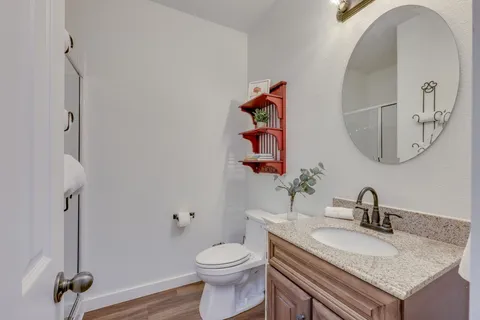 a bathroom with a granite countertop sink and a mirror