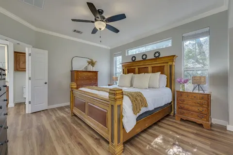 a bedroom with a bed and a chandelier