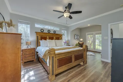 a bedroom with a bed and a ceiling fan