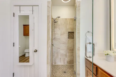 a bathroom with a shower and a sink