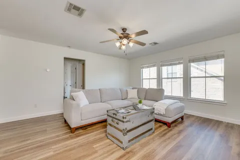 a living room with furniture and a large window