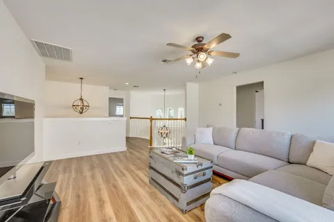 a living room with furniture and kitchen view