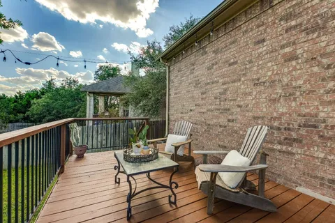 a view of balcony with wooden floor and outdoor seating
