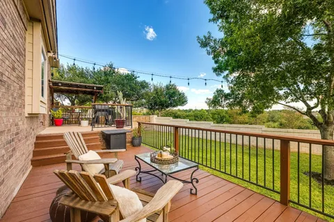 a view of balcony with furniture and wooden deck