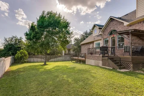 a swimming pool with outdoor seating and yard