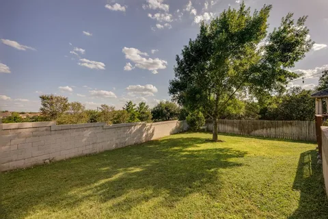 a swimming pool with an outdoor seating and yard