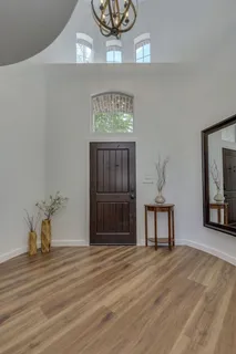 a view of a livingroom with wooden floor and a ceiling fan