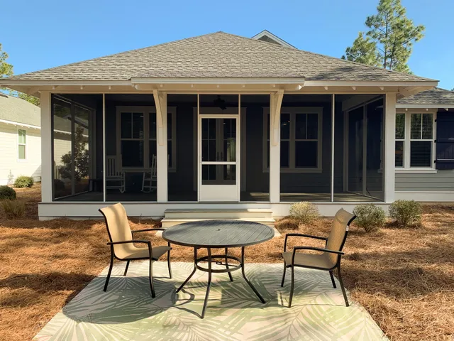 a view of a house with backyard sitting area and porch