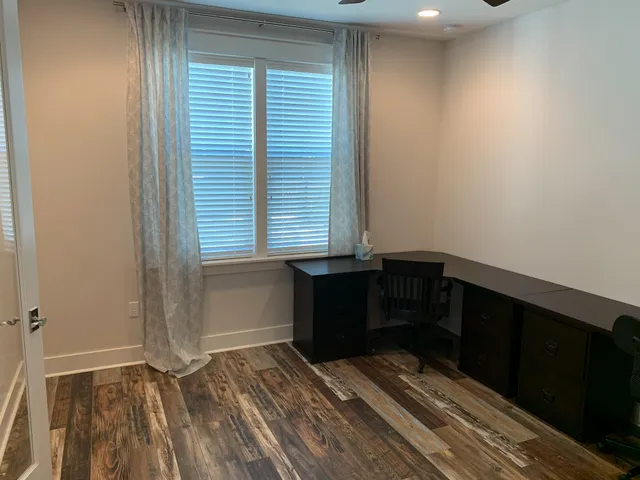 a room with a window and wooden floor