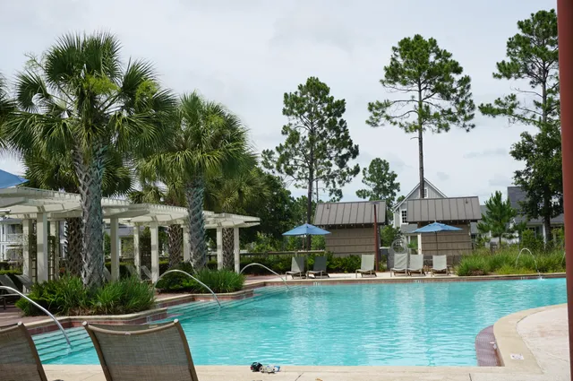 an aerial view of a house with swimming pool garden and patio